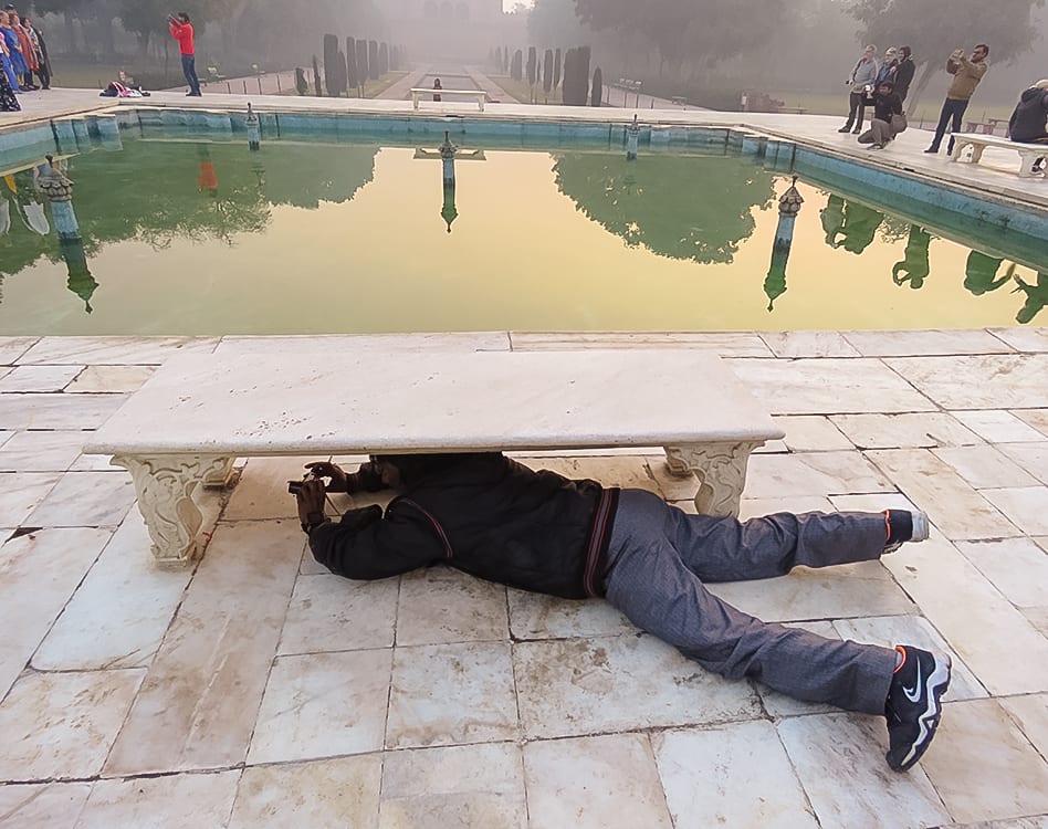Taking photos under a bench