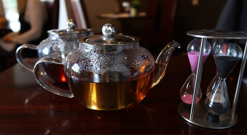 Two elegant glass teapots with brewing timer