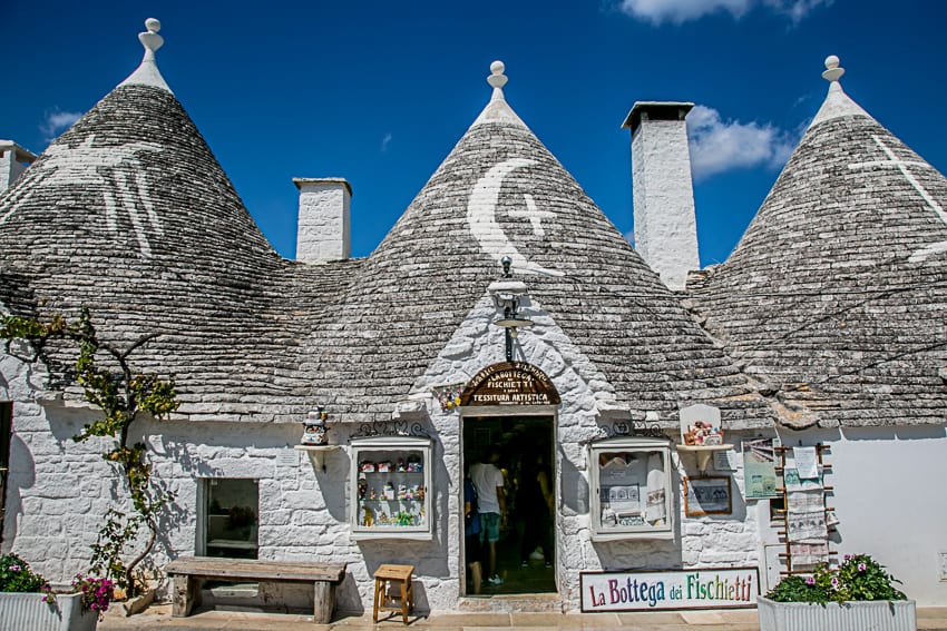 Truillis - typical houses in Puglia Italy with round walls painted white and grey slate pointed roofs