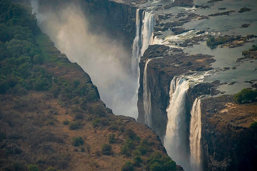 12 Amazing Unesco Heritage Sites In Africa 11 Victoria Falls - waterfalls with spray coming up between the two sides of land