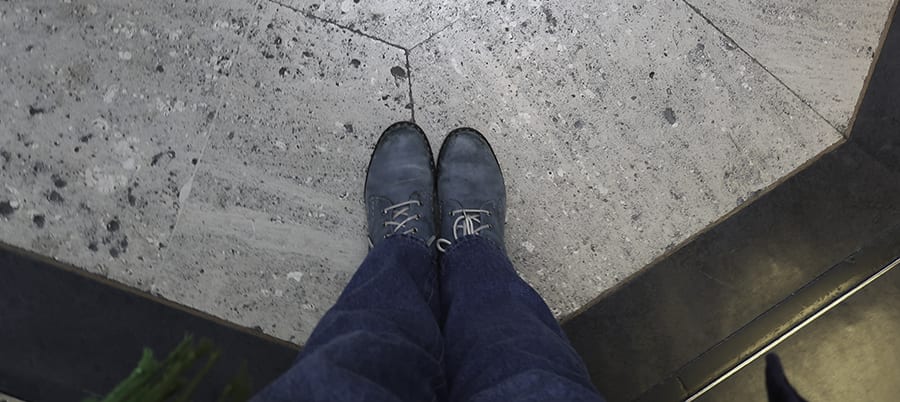 The British Museum, London - 30 Top Tips For Your Visit 10 shot looking down on a pair of blue lace-up boots and jeans standing on a stone floor