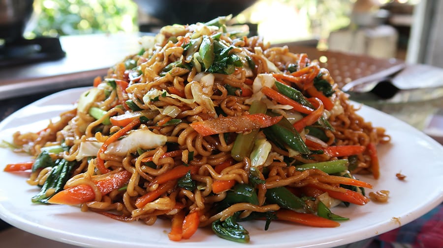 10 Great Reasons to Visit Indonesia 11 white plate of noodles with sliced carrots, cabbage and spring onions