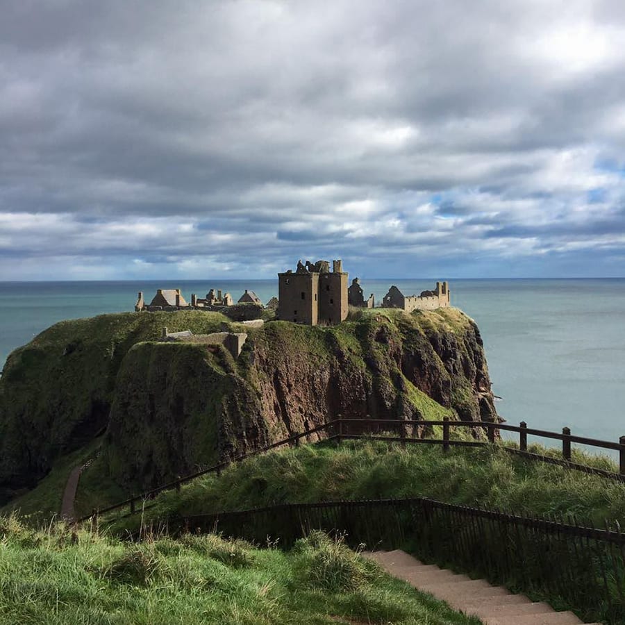 Dunnottar Caslte on an rocky outcrop with the sea below and behind