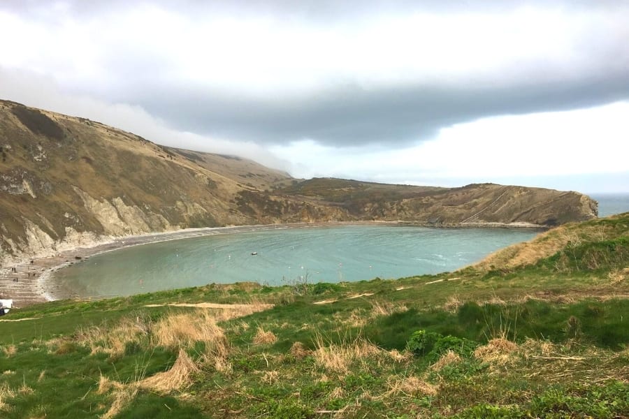 10+ of the Best Weekends in Dorset 6 Lulworth Cove with hills curving around it
