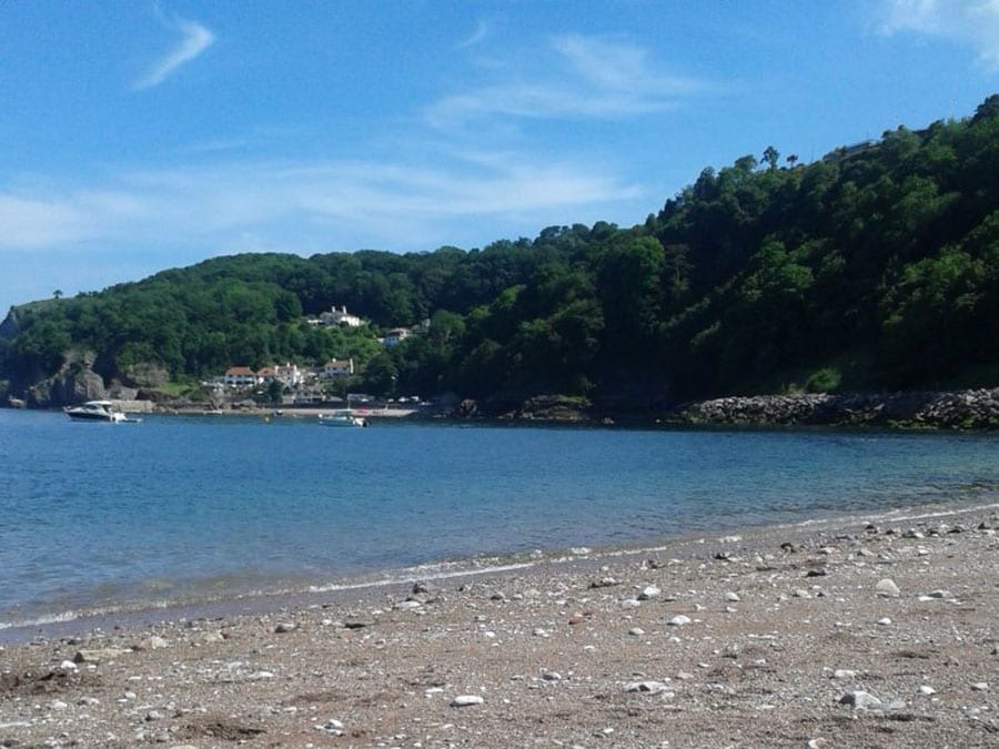 10+ of the Best Weekends in Devon 5 beach with sea and tree covered hills behind