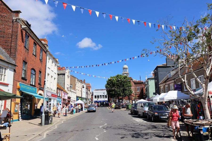 10+ of the Best Weekends in Dorset 13 Bridport High Street with red, white and blue bunting and market stalls on the right