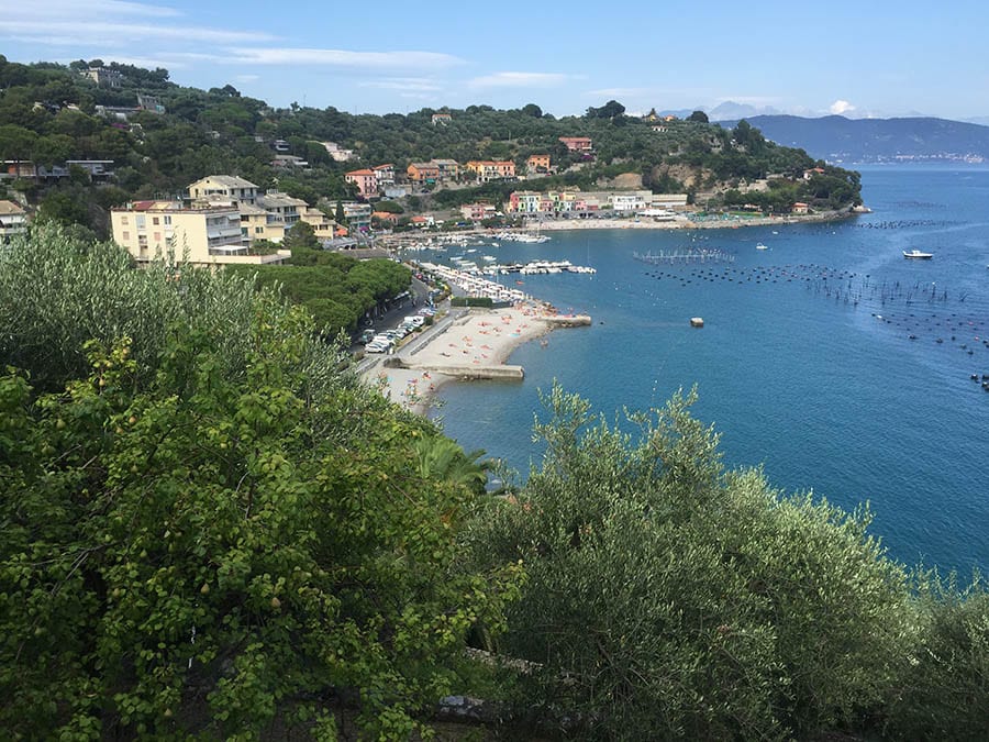 view over the coast to Portovenere with beaches and houses on the left and the sea on the righ