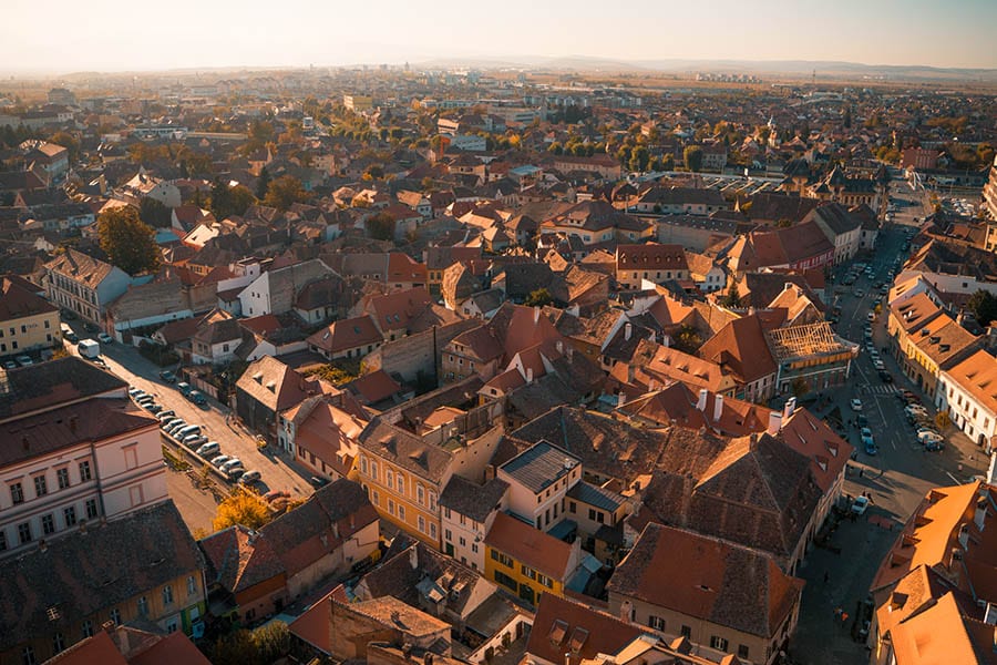 an aerial view of the red roofs of Sibiu in Romania