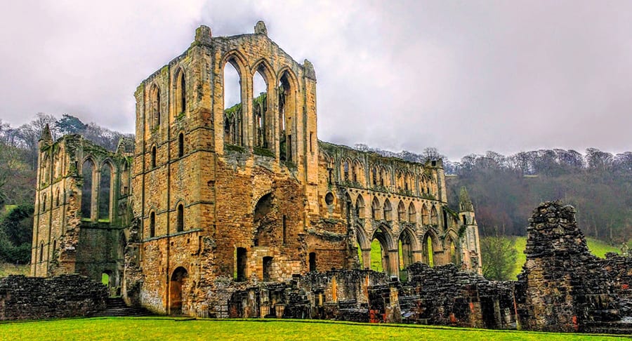 25 Amazing Hidden Gems in England and Wales to discover 4 ruins of Rievaulx Abbey, a gothic abbey with arching empty windows