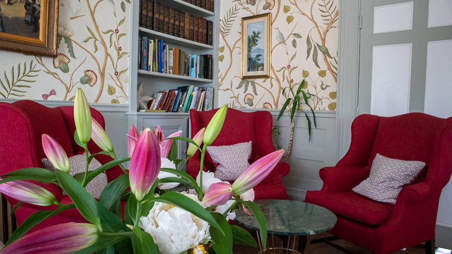 The Burleigh Court Hotel & Restaurant, Luxury in the Cotswolds 17 three red armchairs with pink lilies in the foreground