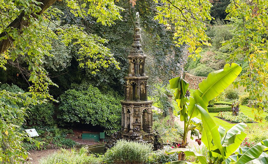 The Absolute Best Cities In The Uk To Visit With Map 7 Ornate tower in Plantation Garden in Norwich with banana trees in the foregroun