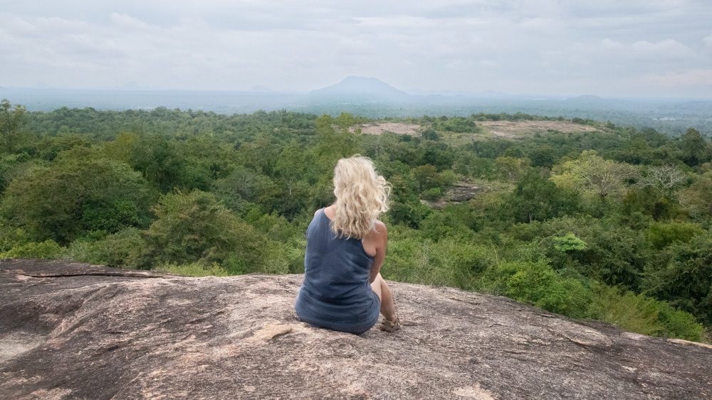 An Eco-Friendly Stay at Wild Glamping Gal Oya, Sri Lanka (2025) 17 Larch sitting on the rocks at Rajagala taking in the view over eastern Sri Lanka