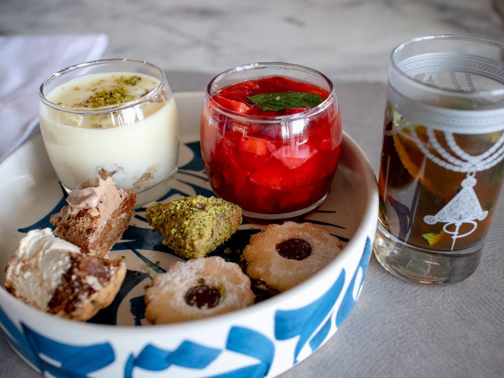 Sawa Taste Of Tunisia: Explore The Amazing Food Of Tunisia 56 Selection of puddings in blue and white bowl with mint tea in a painted glass
