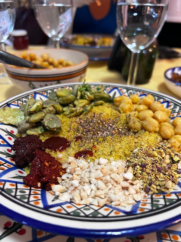 Sawa Taste Of Tunisia: Explore The Amazing Food Of Tunisia 51 plate with couscous, chickpeas, broad beans, chopped nuts, pistasios and harissa