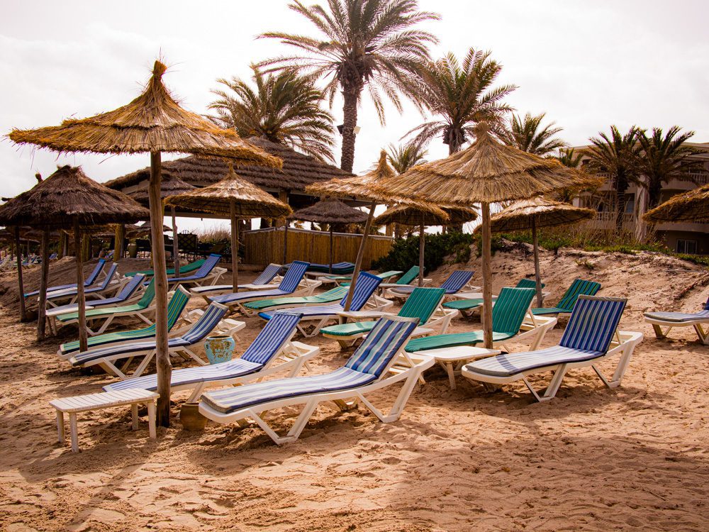The Elegant VIP Suites at The Royal Thalassa Monastir 28 a group of chairs and umbrellas on a beach