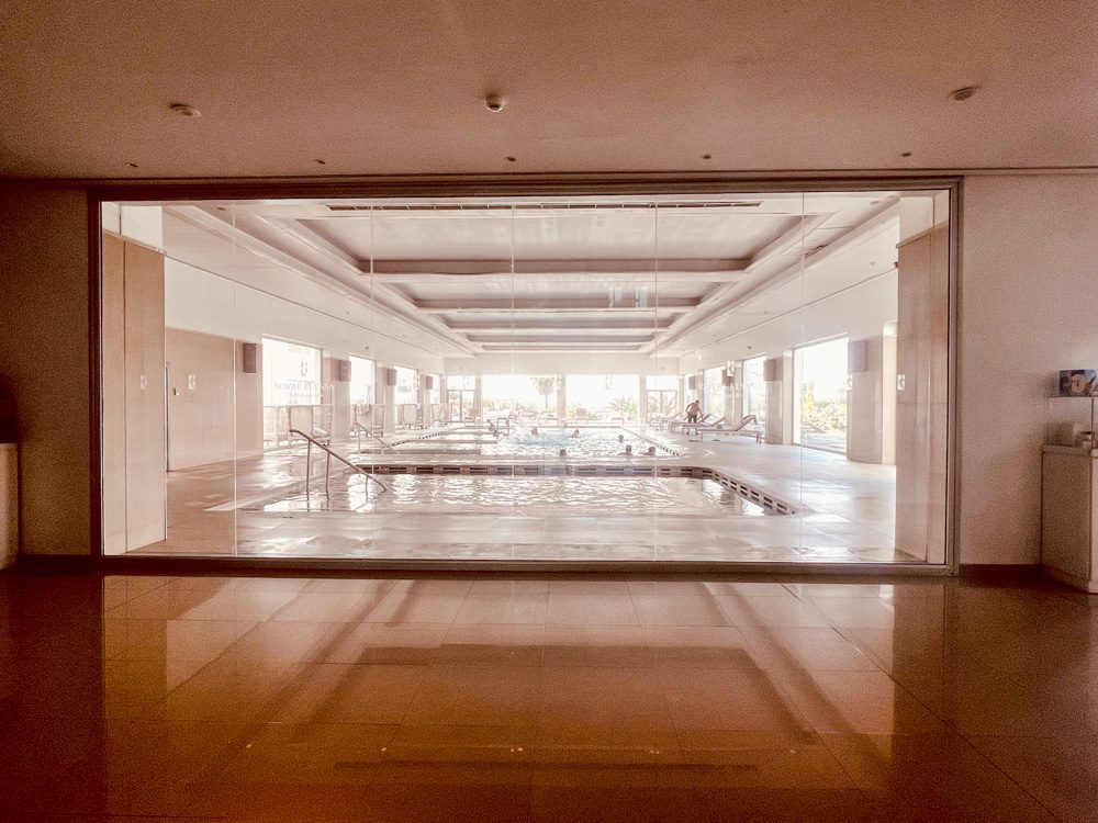 The Elegant VIP Suites at The Royal Thalassa Monastir 10 a large glass wall with a pool in it