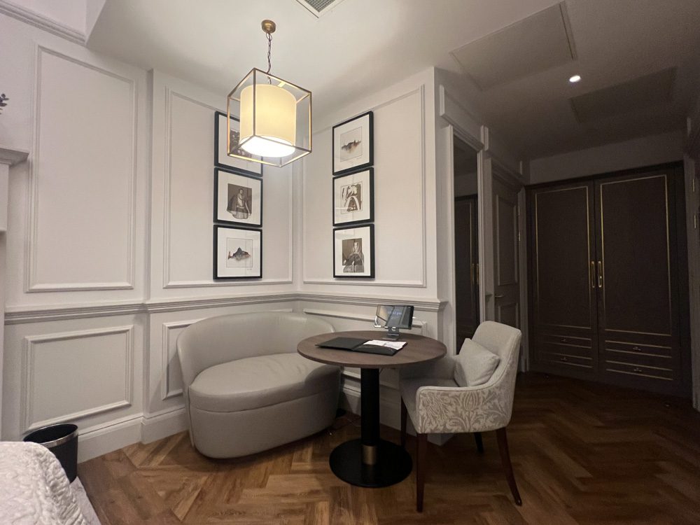 Staying at the Luxury RÌGH Residences, Edinburgh (2024) 12 Cosy seating area with grey sofa, and grey upholstered chair