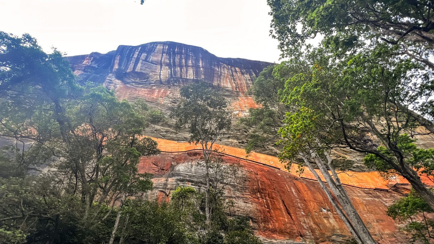 Climbing The Amazing Lion Rock In Sigiriya: The Ultimate Guide (2025) 2 View of the rock face up to the summit from the base