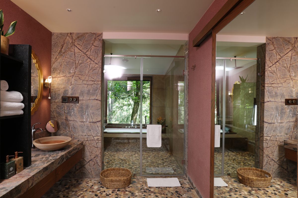 Stunning Timbertales In Coorg: A Tranquil Escape In Karnataka (2025) 10 The light and spacious bathrooms with terracotta walls, tiled floors and glass wall separating the bath and shower
