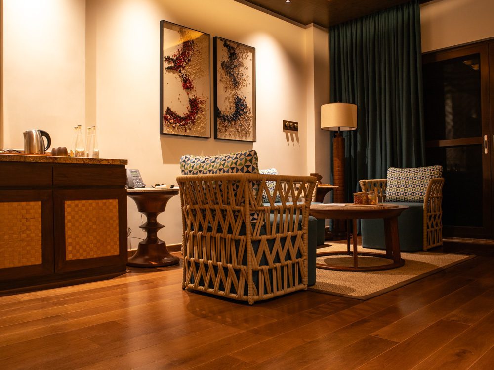 Stunning Timbertales In Coorg: A Tranquil Escape In Karnataka (2025) 6 wicker chairs with blue seats and geometric pillows