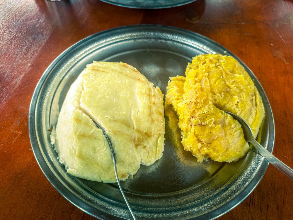 What to Eat in Uganda: A Delicious Journey Through Uganda’s Best Dishes 4 What to eat in Uganda? Posho and Matooke on a silver plate with spoons.