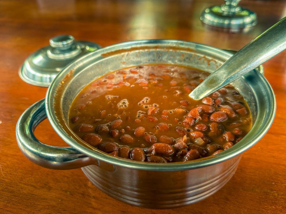 What to Eat in Uganda: A Delicious Journey Through Uganda’s Best Dishes 15 Bean Stew in a silver metal dish with spoon