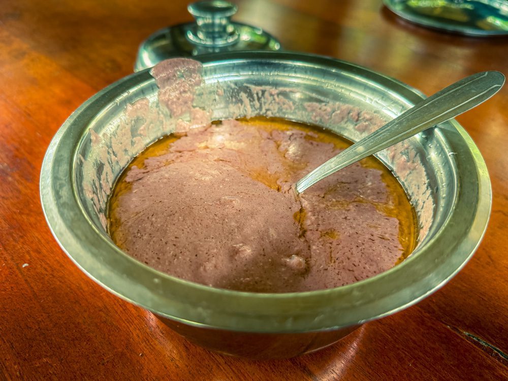What to Eat in Uganda: A Delicious Journey Through Uganda’s Best Dishes 12 Fresh pink groundnut sauce in a silver metal dish with spoon