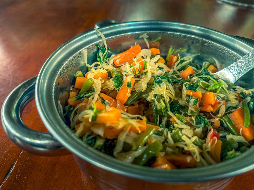 What to Eat in Uganda: A Delicious Journey Through Uganda’s Best Dishes 13 Vegetable Stew in a silver metal dish with spoon
