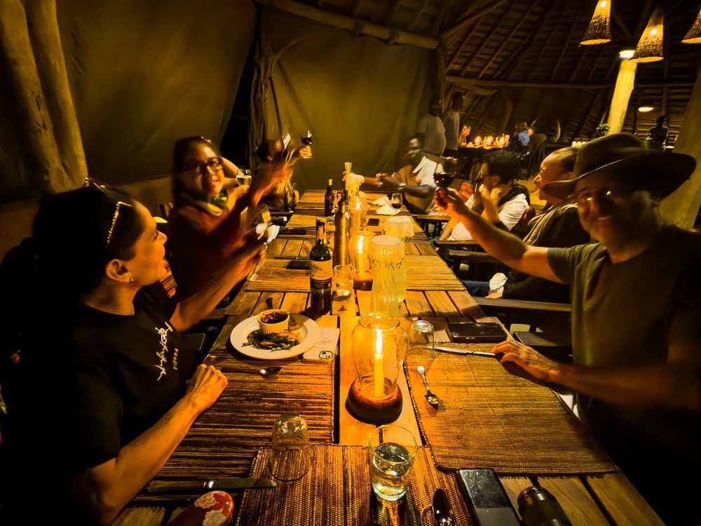 table of people dining and raising their glasses
