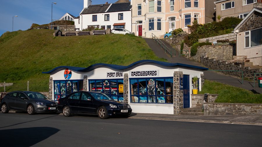 20+ Of The Best Things To Do In Port Erin, Isle Of Man 3 One of the best things to do in Port Erin is to go Paddleboarding. Port Erin Paddleboarders has a blue wave roof and large windows.