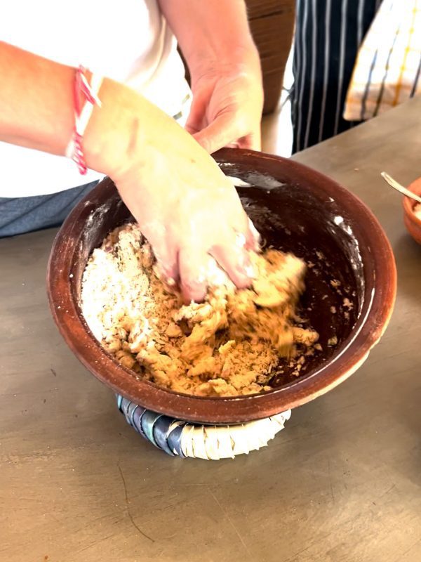 The Best Food In Sri Lanka To Eat (Including 5 Easy Recipes!) 16 Mixing the roti dough in clay bowl