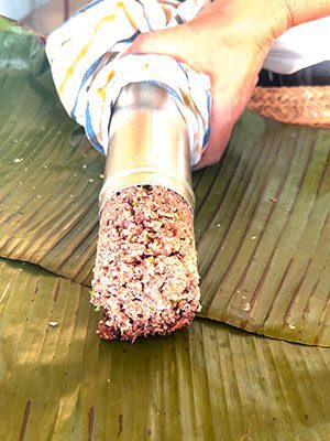The Best Food In Sri Lanka To Eat (Including 5 Easy Recipes!) 21 the pittu being squeezed out of the pittu steamer